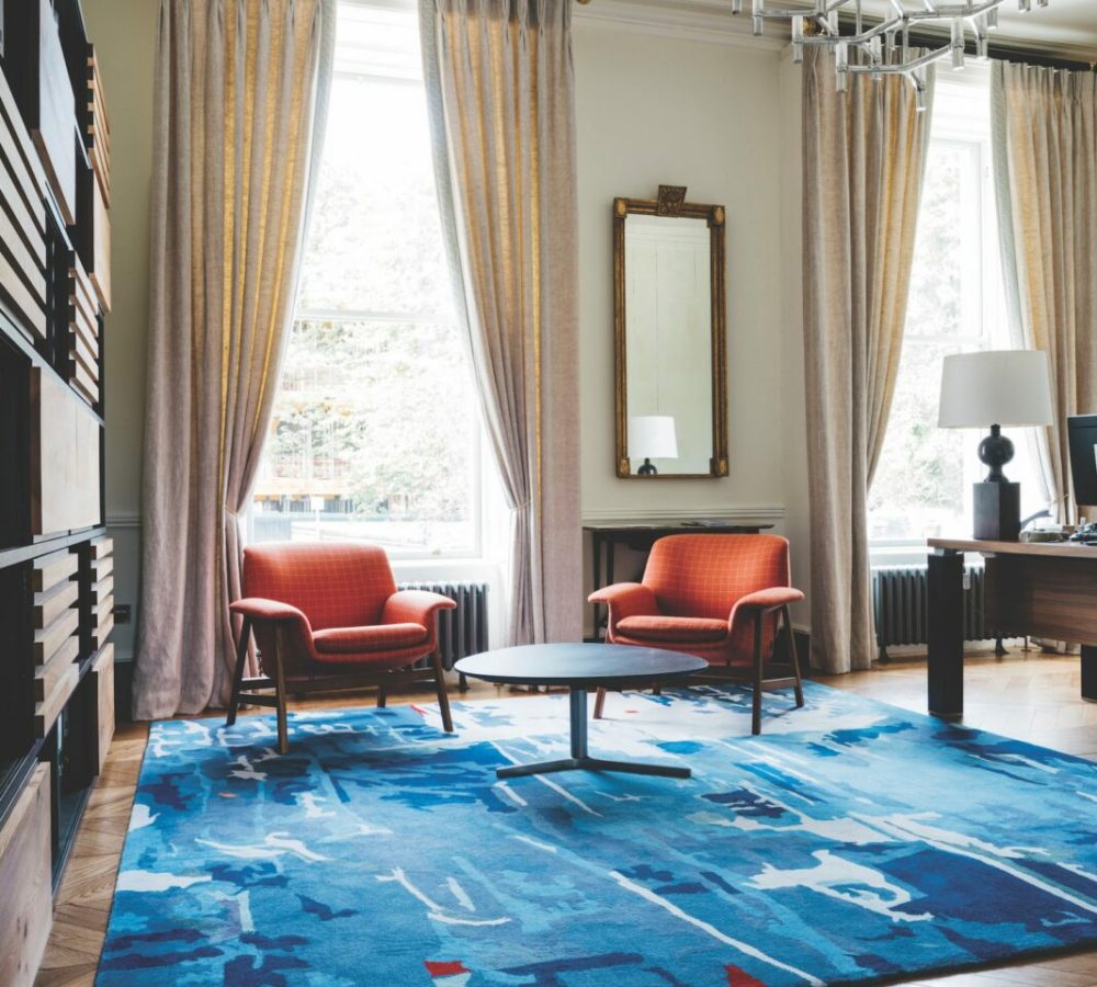 Office rug timber flooring desh shelving chairs retro